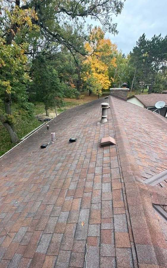 Ridge line of a multicolor shingle roof on a split-level home on Larson Court in Shoreview, MN, during a Repair King inspection, October 2023