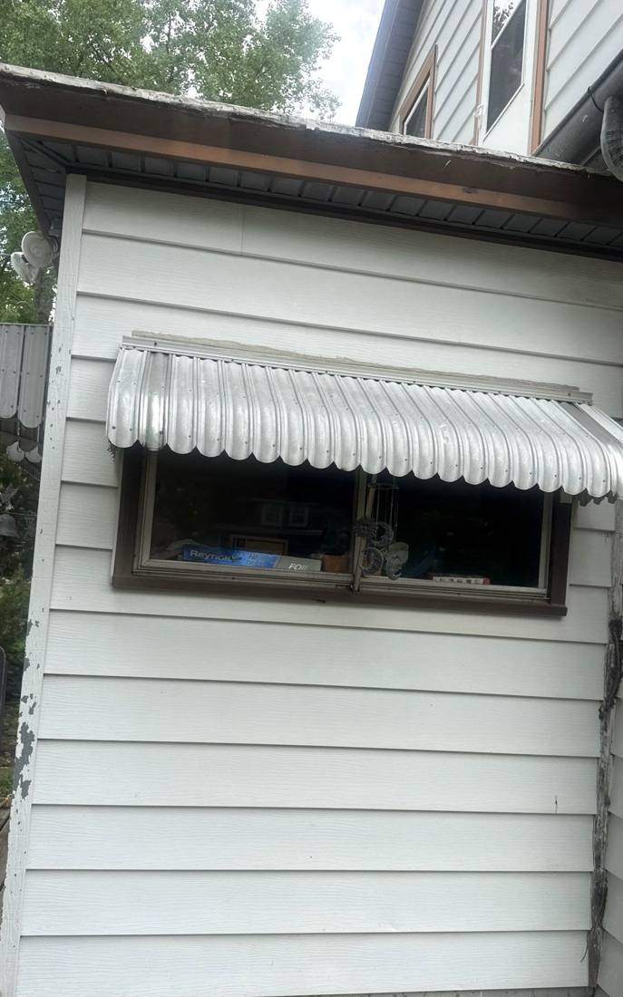 Siding and window awning on a New Ulm home checked during an inspection, May 2026