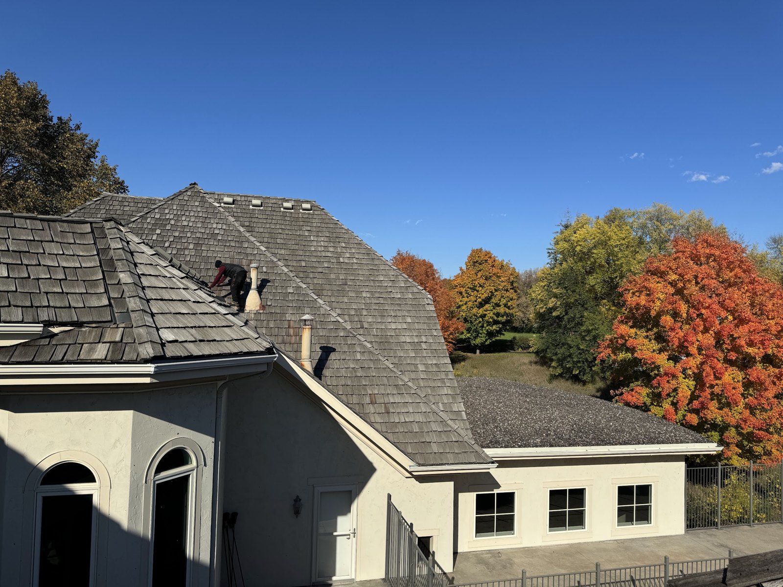 Repair King inspector checking valley metal on a cedar shake roof during a forensic inspection in Minnesota