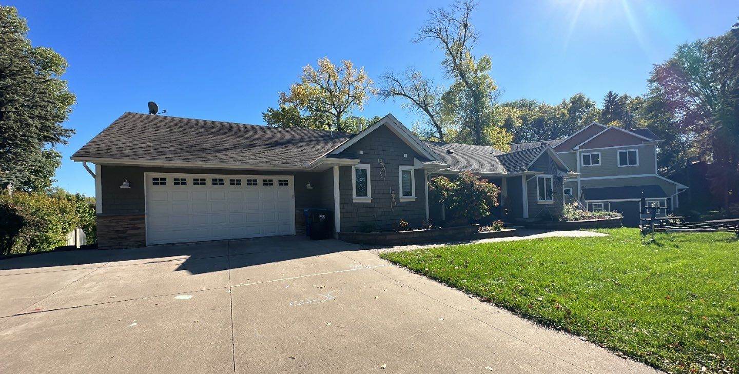 Wide view of a New Brighton, MN home and attached garage roof photographed by Repair King during a roof inspection