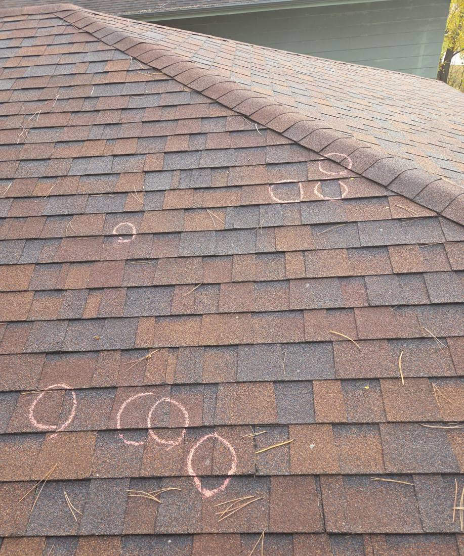 Chalk-marked hail hits on an Eagan roof slope during an inspection