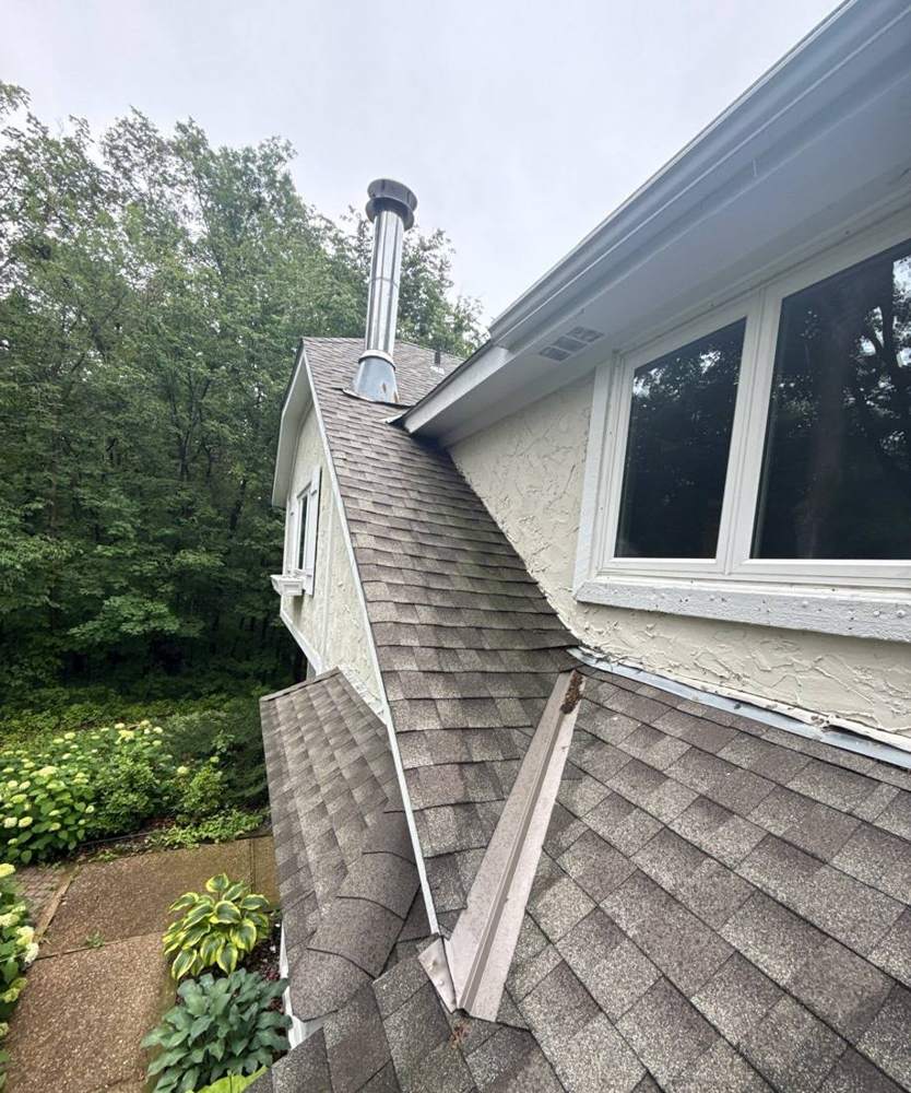 Valley and dormer detail on a Waconia roof, showing flashing where two roof planes meet a window wall, June 2025