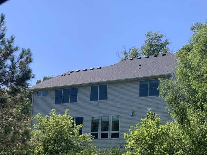 Rear of the two-story Rockford home, with its roofline and windows, July 2020