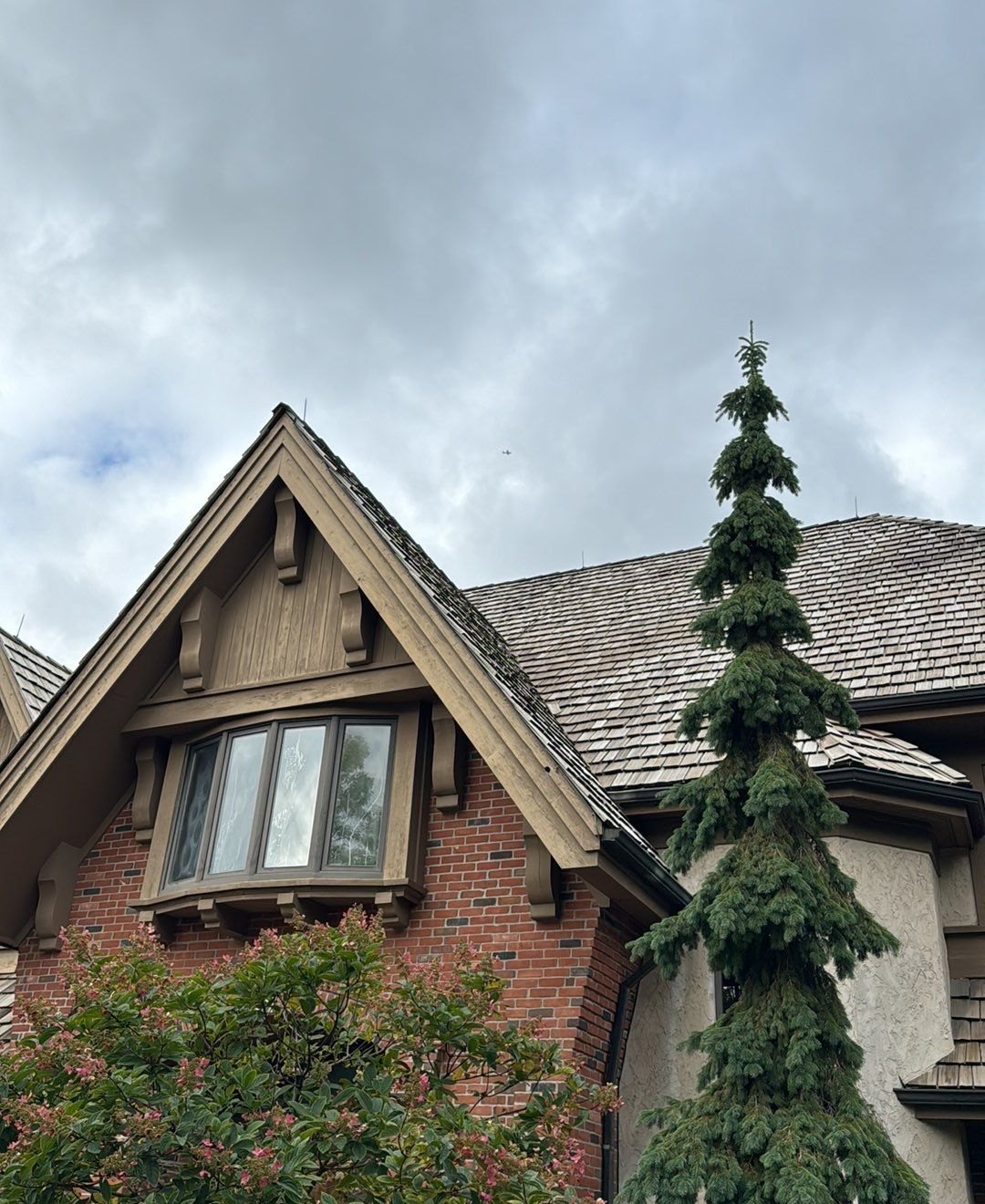 Brick front gable and cedar shake roof on a home near Lake Minnetonka, photographed during Repair King's October 2023 inspection