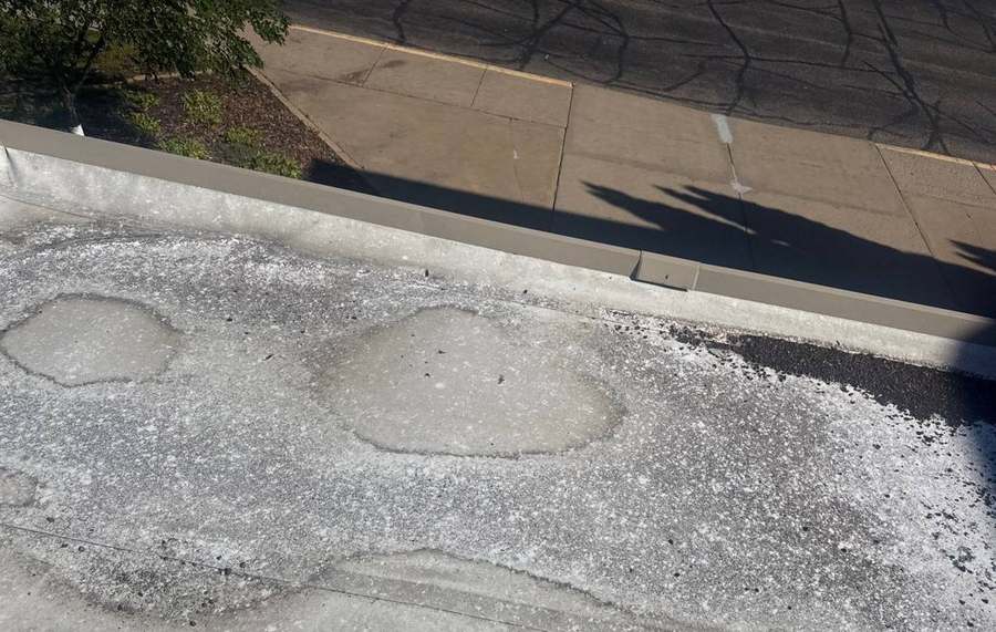 Ponding rings along the parapet edge of the low-slope roof at Minnetonka Christian Academy, September 2025