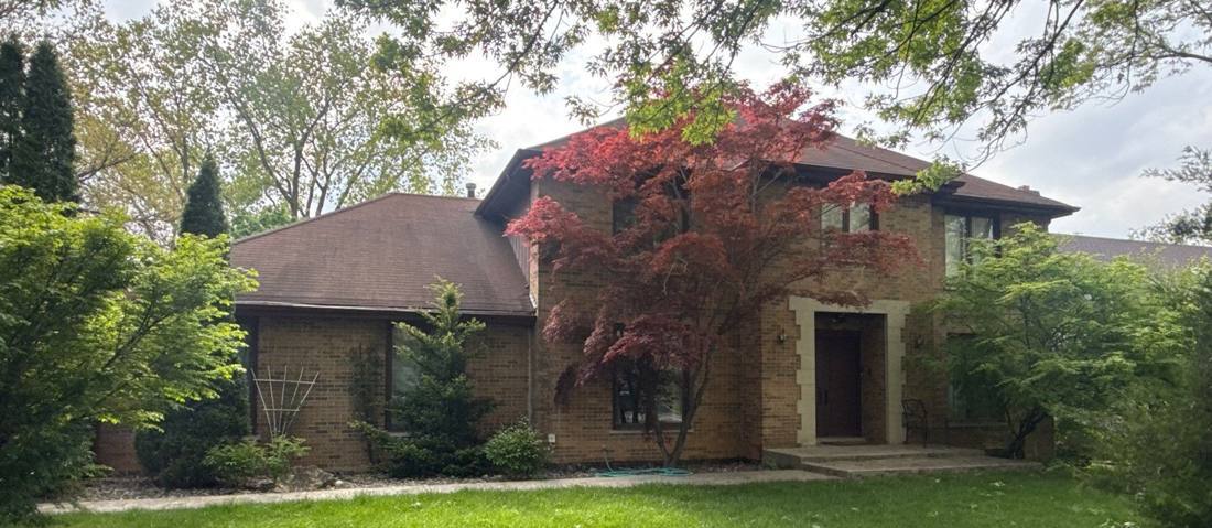 Two-story brick home in Burr Ridge photographed during a spring 2026 roof inspection