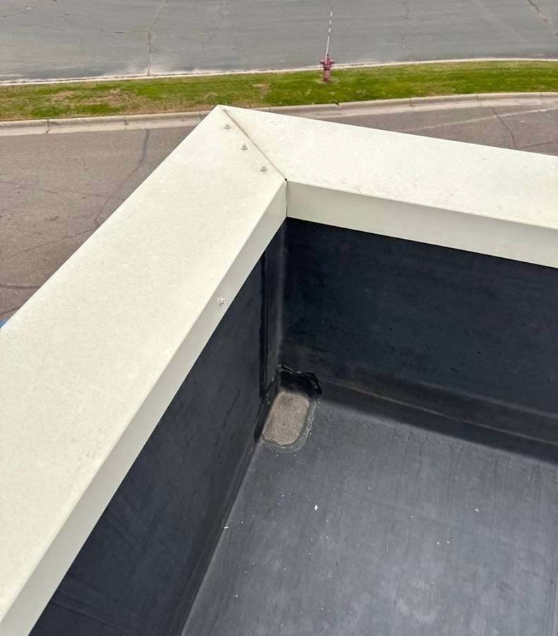 Parapet coping corner and low-slope roof at the Delano Dairy Queen, November 2023