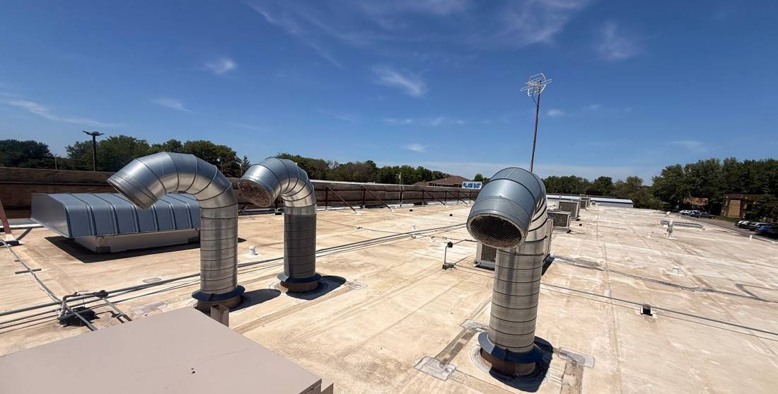 Rooftop ductwork and vent stacks on the Village East Center roof in Mankato, inspected by Repair King