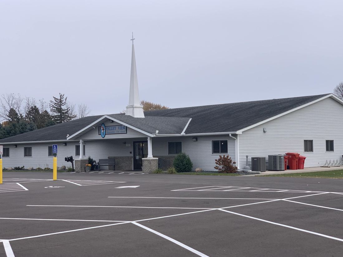 Valley View Assembly of God in Lake City in the fall, with its Repair King roof and siding and the newly paved lot