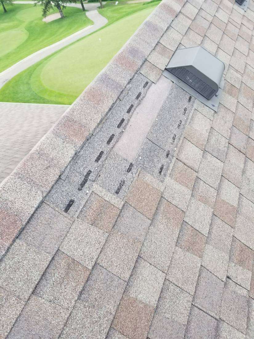 Ridge vent and box vent on the Owatonna Country Club clubhouse roof, with a green and fairway below