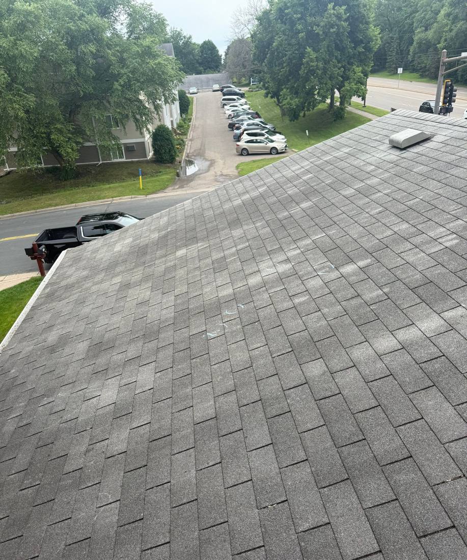 Chalk-marked hail hits on a low-slope roof overlooking a New Brighton parking area, June 2025