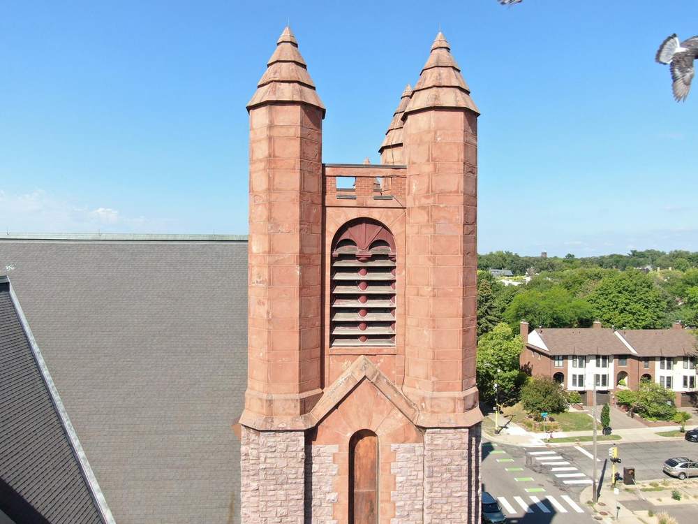 Sandstone bell tower with stepped spire caps