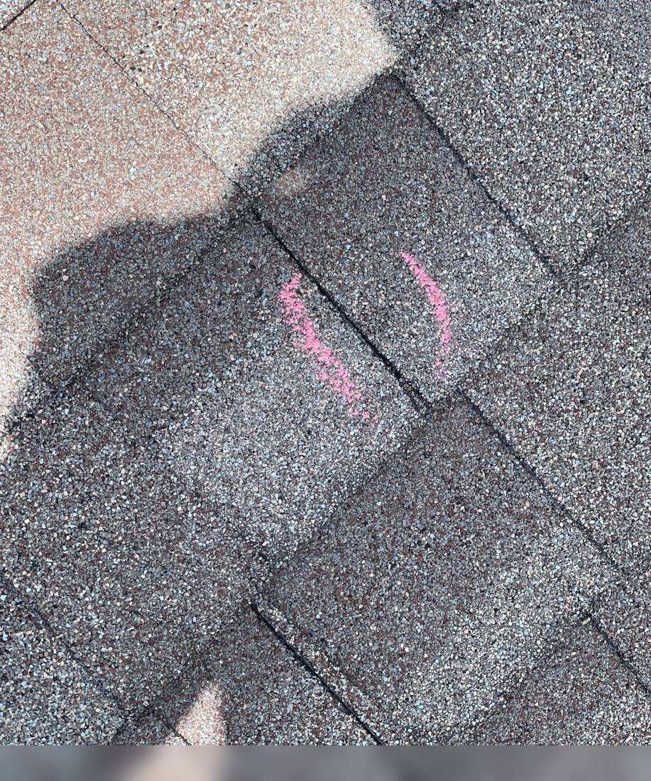 Hail hits chalk-marked on a Bowlus roof during an inspection, May 2022
