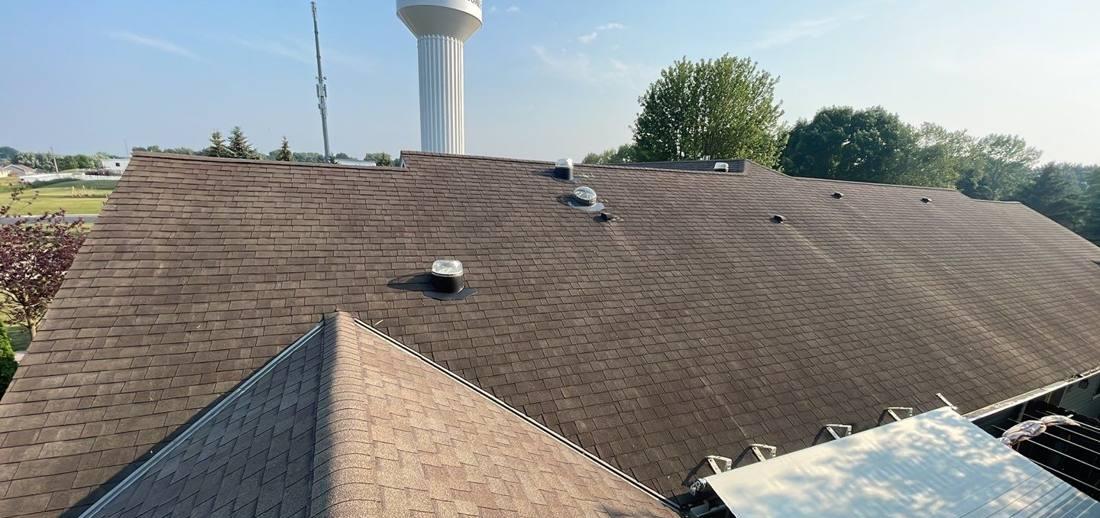 Aerial view of a Montgomery roof with the city's water tower in the background, June 2023