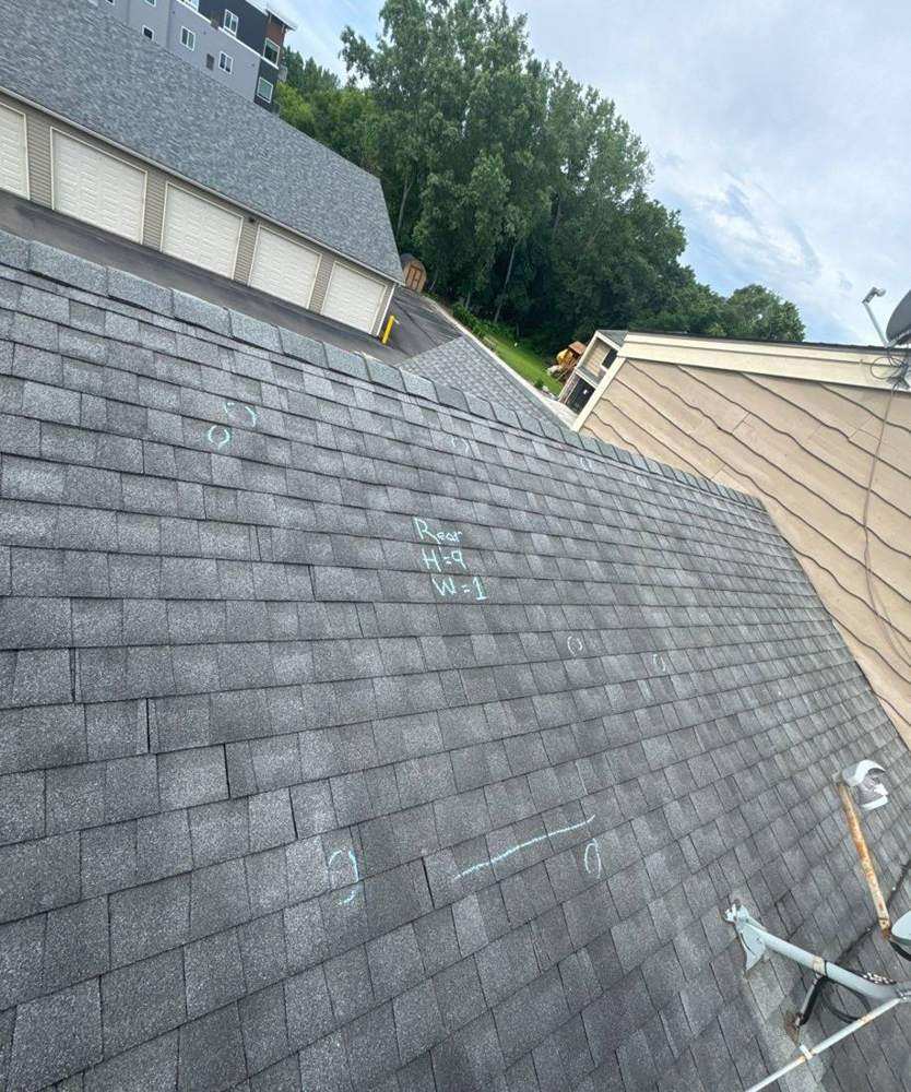 Chalk-marked shingle roof at Elk River Lodge & Suites in Elk River, MN, photographed by Repair King in 2024