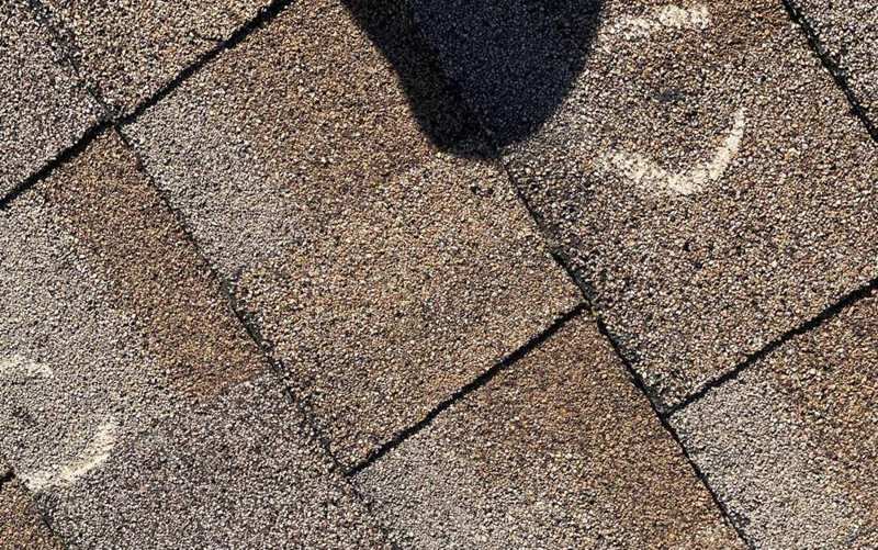 Chalk-marked hail hit on an asphalt shingle roof in Big Lake, May 2022