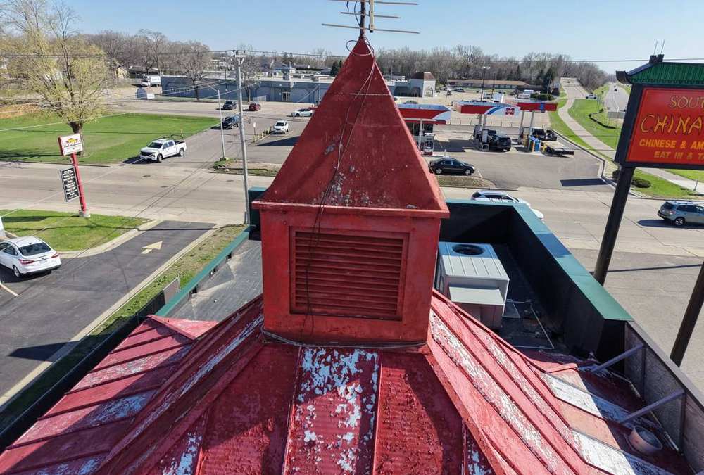 Aerial view of the red metal pagoda roof and cupola on Southern China Café, Division St W, Faribault, MN, April 2026