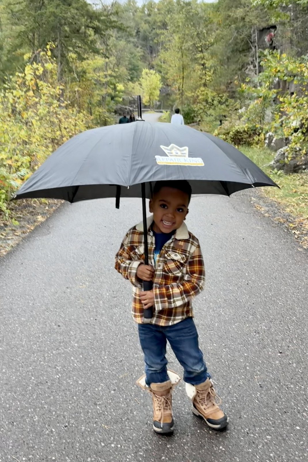 Manny holding a Repair King umbrella
