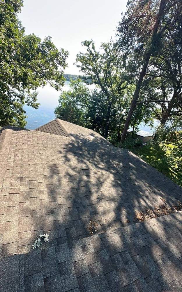 Rooftop view toward a lake near Annandale during a roof inspection, July 2023
