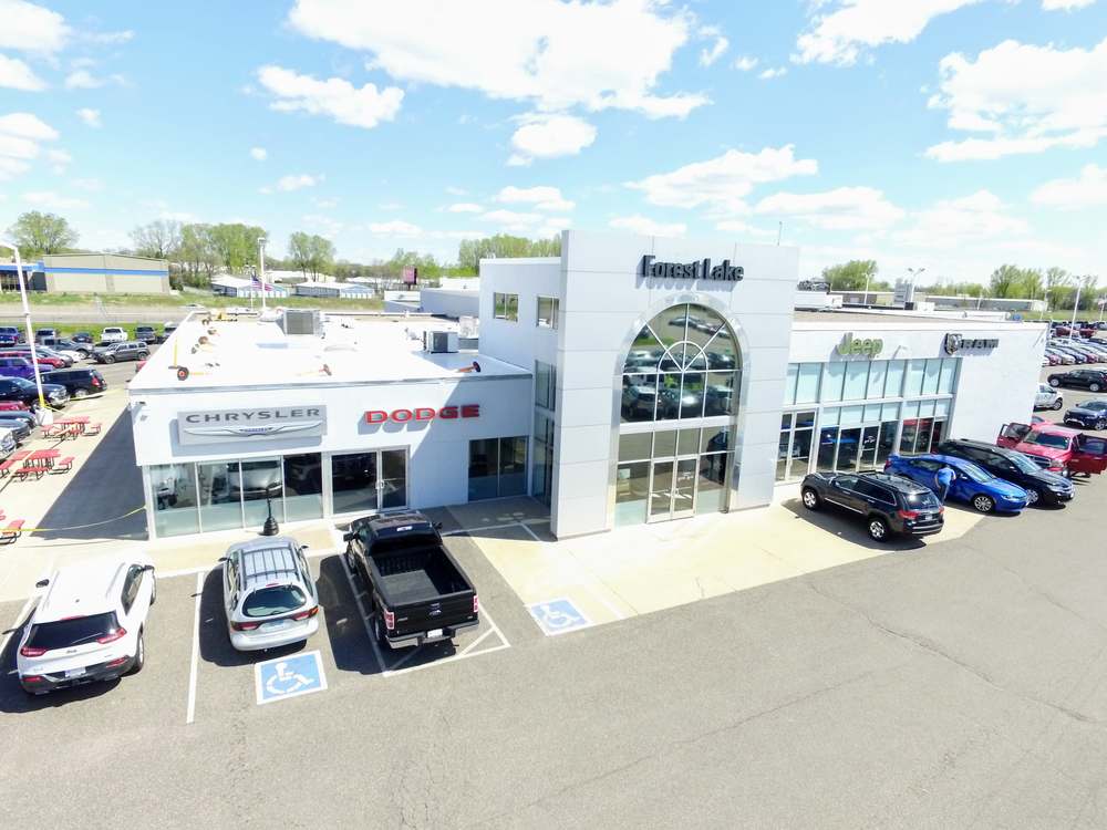 Drone view of Forest Lake Chrysler Jeep Dodge in Forest Lake, MN, showing the Chrysler and Dodge storefront under the white Duro-Last roof installed by Repair King
