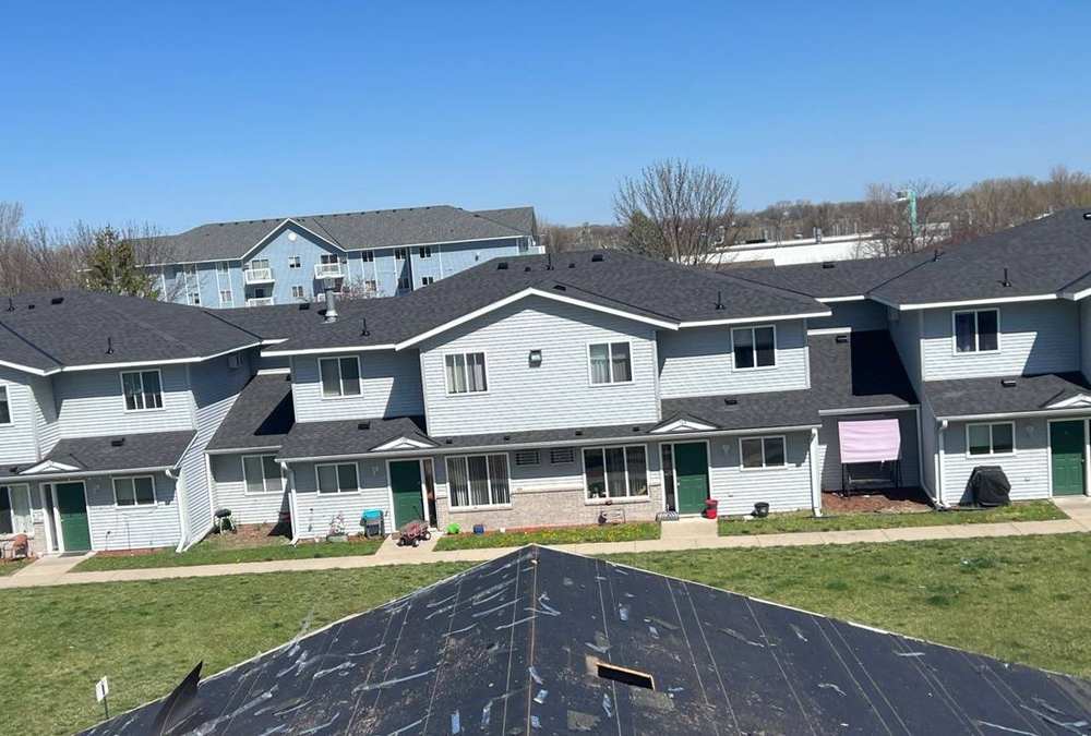 Waters Edge townhome buildings in Howard Lake under a clear sky, April 2024