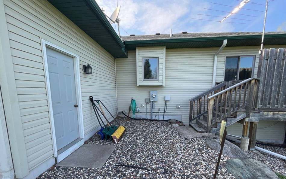 Rear entrance and deck of a Princeton home photographed during a roof and siding inspection, May 2022