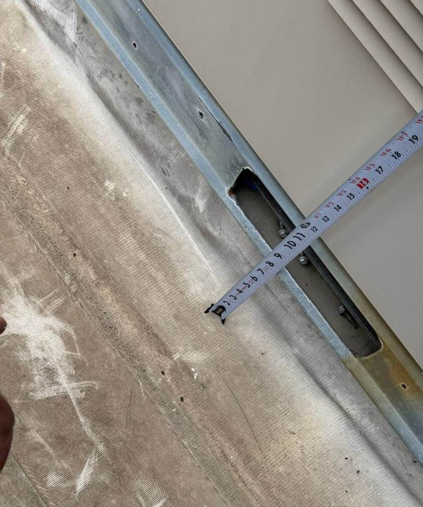 A tape measure on an opening at a metal edge detail on the HOPE Community Academy roof in St. Paul, October 2024