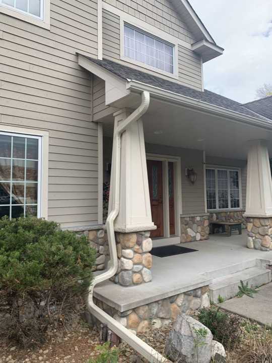 Front porch with river-rock columns on a two-story home in north Maple Grove, MN during a Repair King storm inspection, September 2019