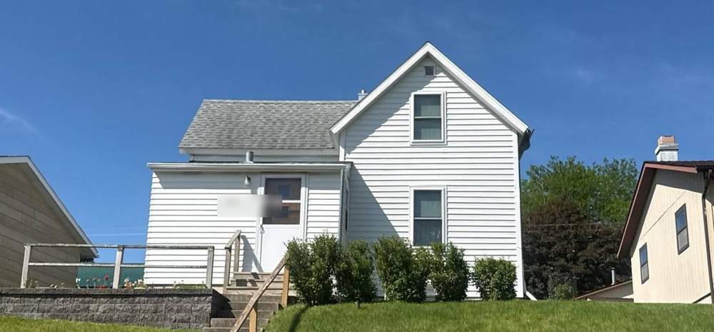 Two-story home near North State Street in New Ulm during a roof inspection, May 2026