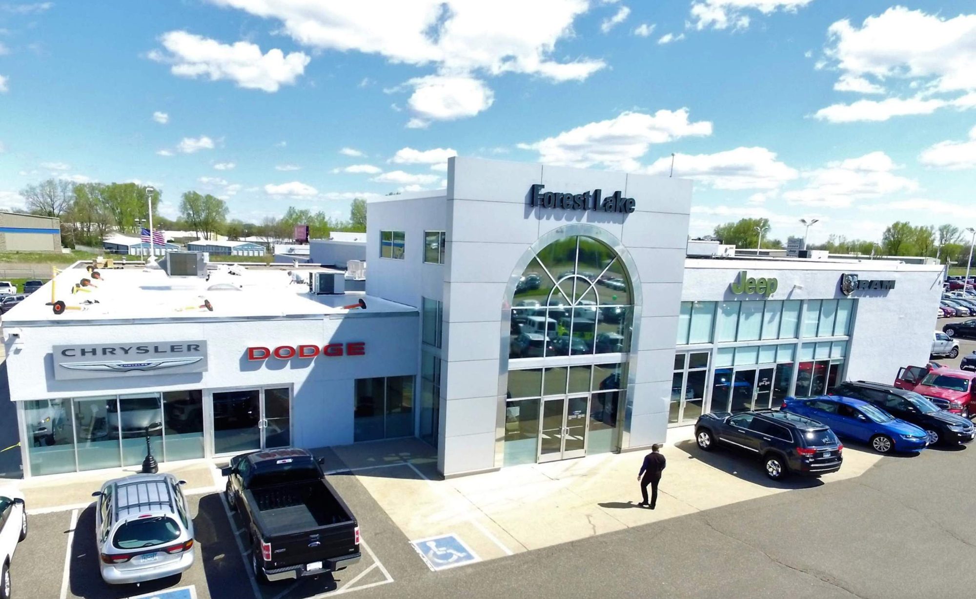 Auto dealership in Forest Lake MN with a new flat roof by Repair King, aerial photo