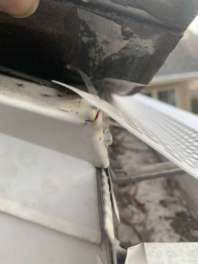 Bent perforated gutter guard and a split gutter end cap on a Penn Place townhome in North St. Paul, MN