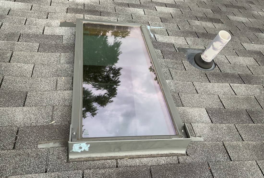 Skylight flashing detail on a Farmington roof during an inspection, July 2023