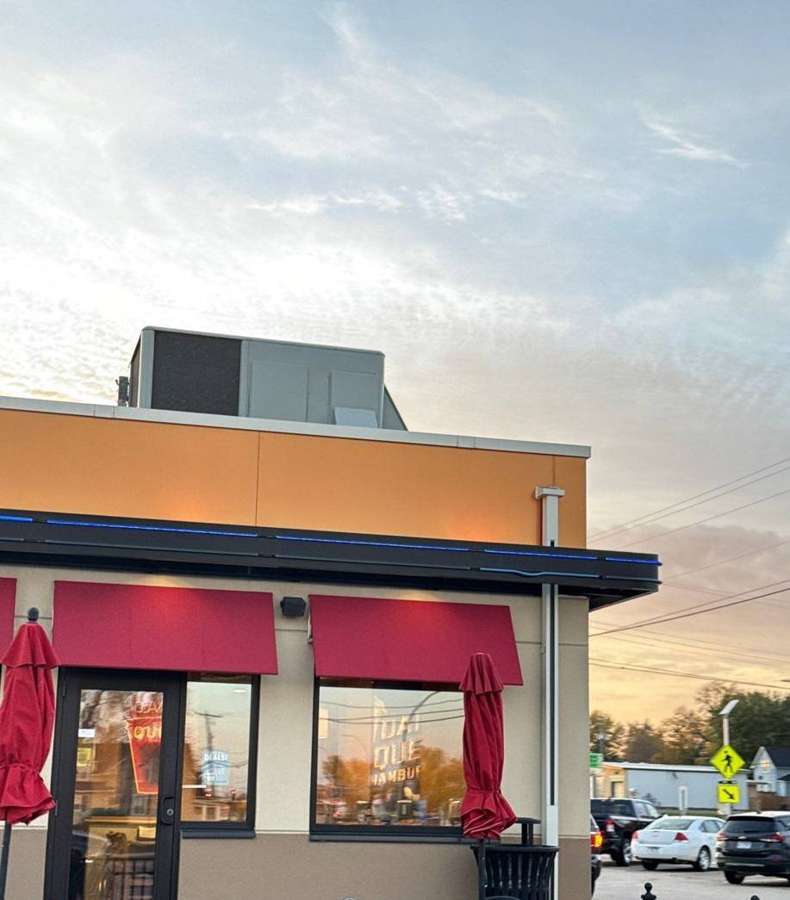 Dairy Queen Grill & Chill in Cokato, MN, with its parapet roof and red awnings, October 2023