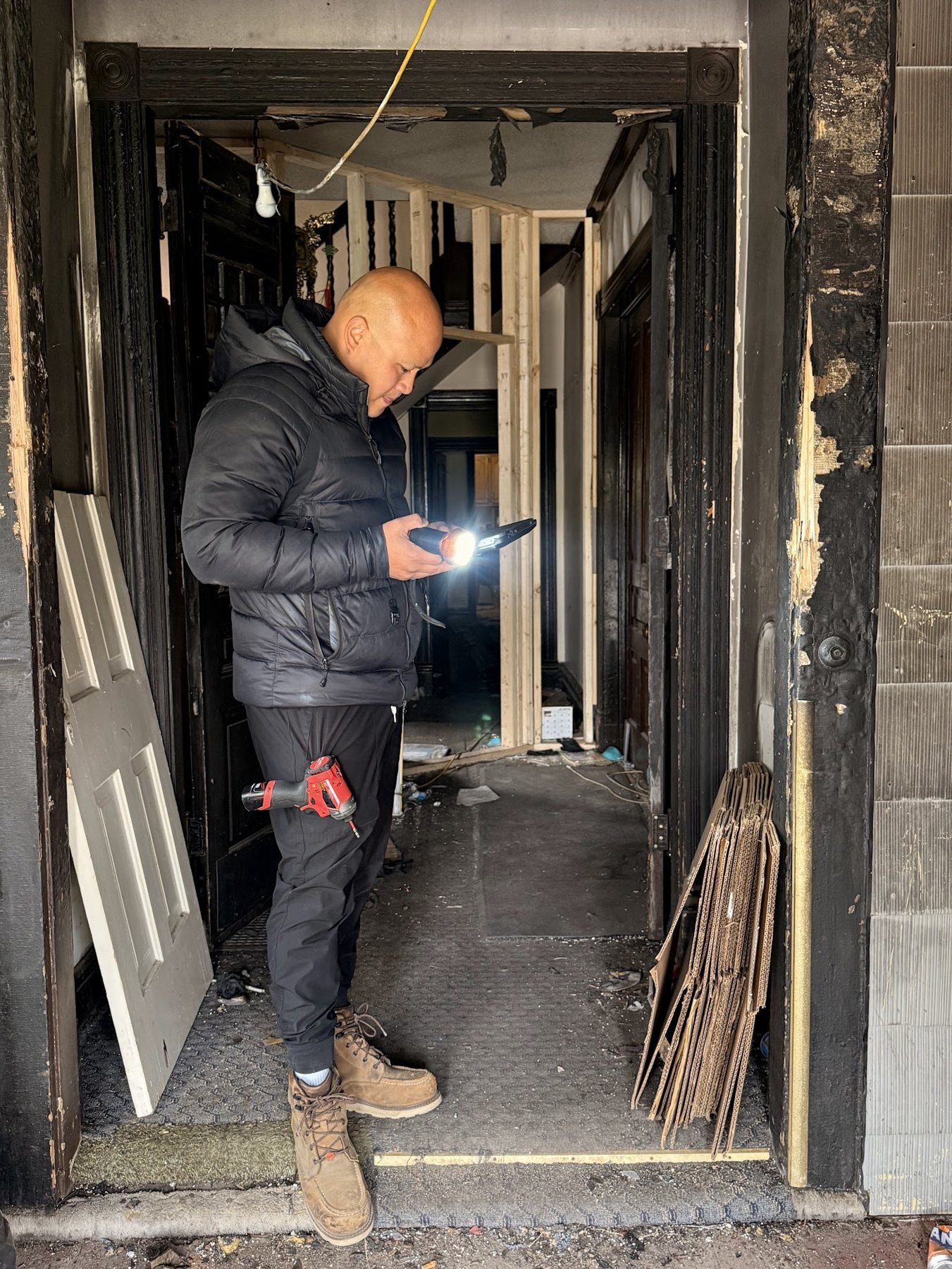 Repair King inspector walking a fire-damaged home entry