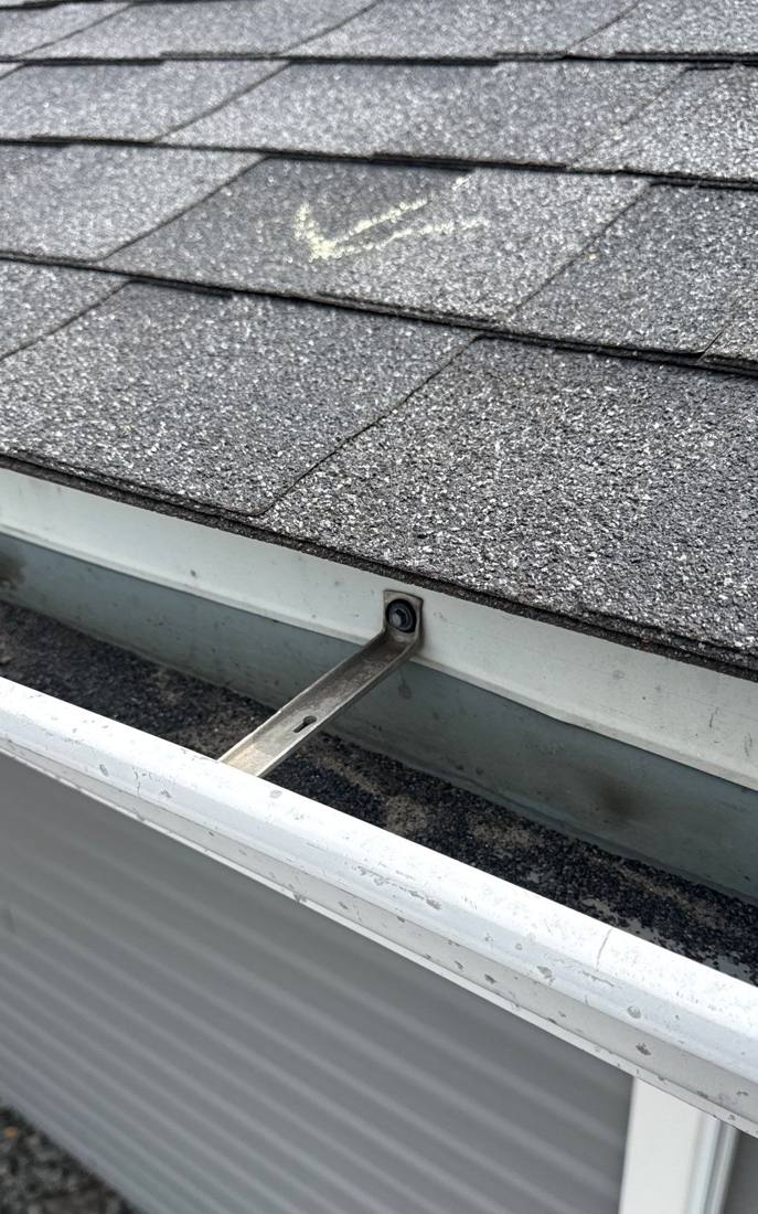Gutter hanger and chalk-marked hail hit on a Lake City church roof, April 2026
