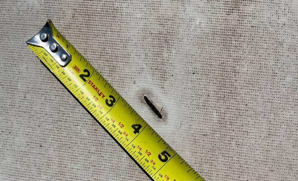 Hail hit chalk-marked and measured on the iStorage roof in St. Louis Park, April 2024