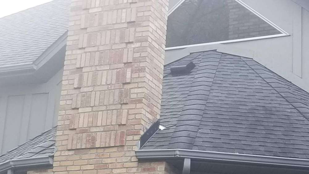 Brick chimney and shingle roof on a Champlin two-story, October 2018
