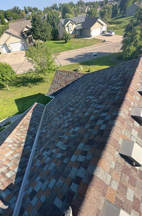 Looking down a roof slope toward the street in an Annandale neighborhood, July 2023