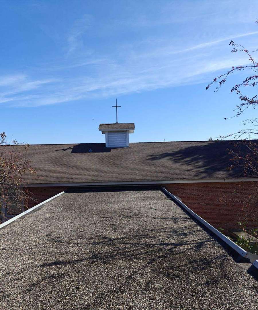 Cross and cupola on the shingled roof of the Creekside UCC (formerly Mayflower Community Congregational Church) building in Minneapolis