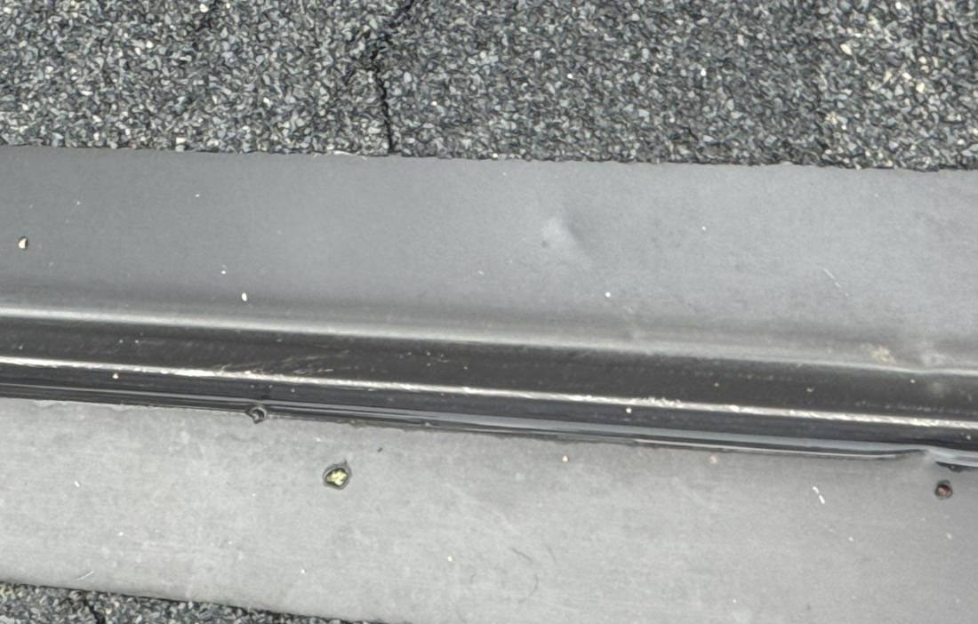 Ridge cap flashing seam inspected on a Clearwater roof, July 2024