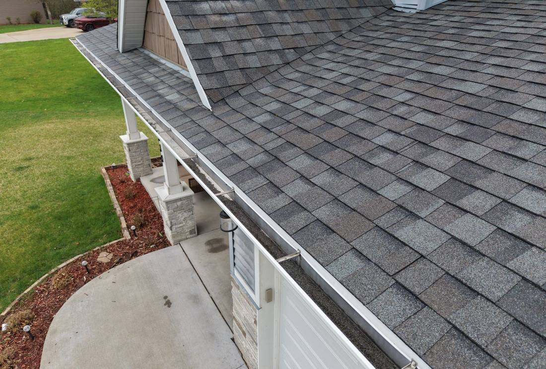 Gray architectural shingles over the front porch of a Red Wing home, April 2026