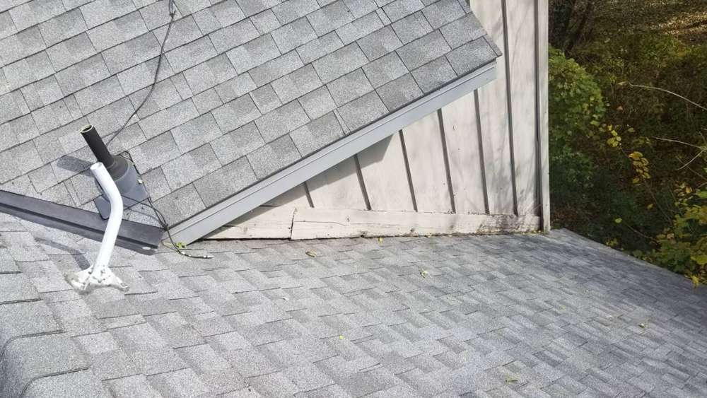 Roof-to-wall joint and vent pipe where the upper story meets the lower roof on a Champlin home, October 2018