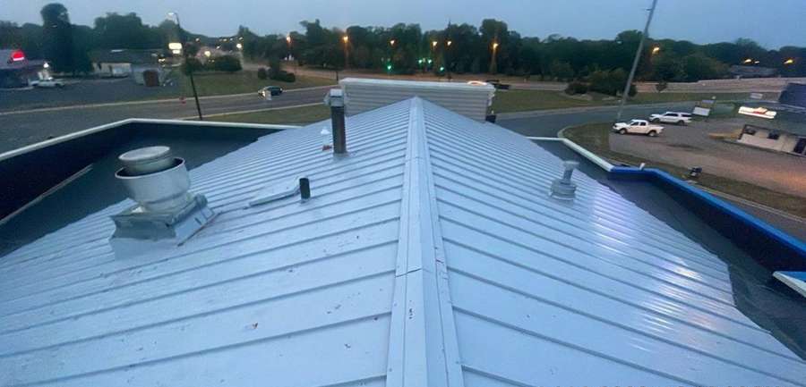 Metal roof panels and roof vents on the Delano Dairy Queen during a hail inspection, July 2023