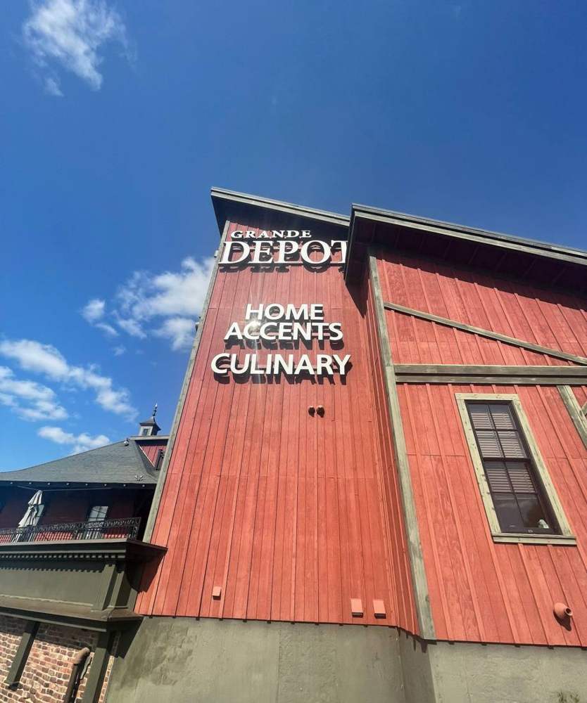 Red board-and-batten wall and Grande Depot sign on the building in St. Cloud, MN, during a Repair King inspection in September 2021