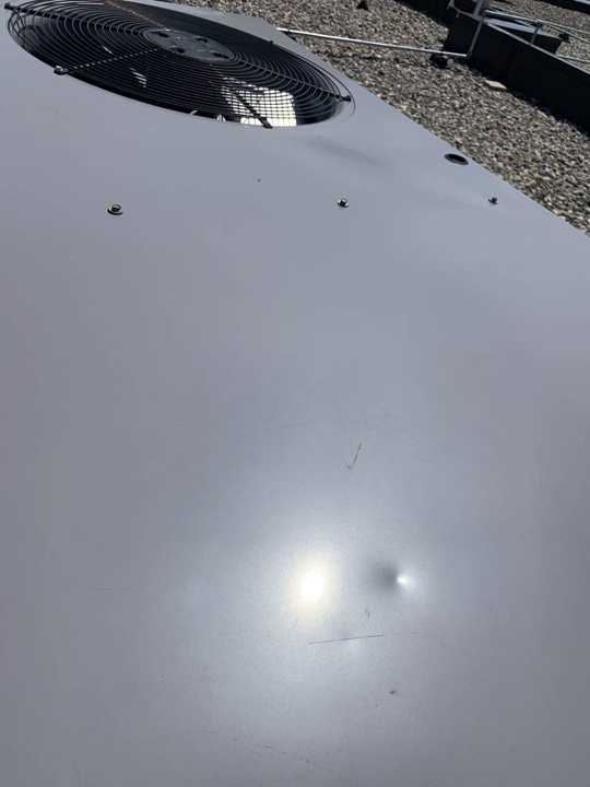 A dent in the metal coping at the edge of the Paradise Car Wash roof in Maple Grove, August 2019