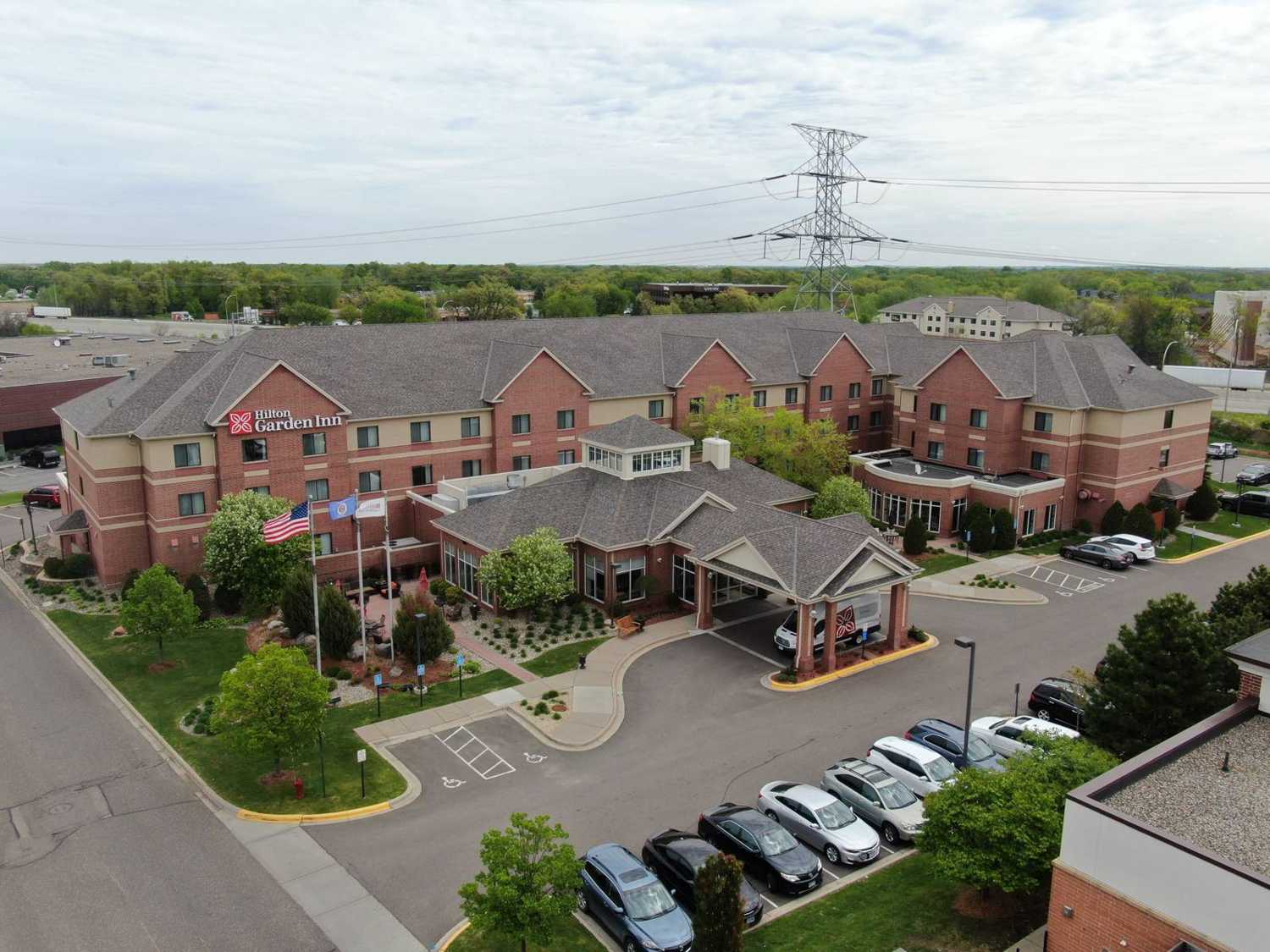 Drone photo of the Hilton Garden Inn Minneapolis/Maple Grove on Vinewood Lane in Maple Grove, MN, with its hip-and-gable shingle roof, during a Repair King roof inspection in May 2019