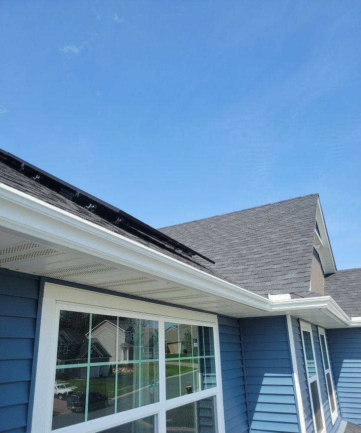 Roofline and gutter detail on a Shakopee home with solar panels, May 2022