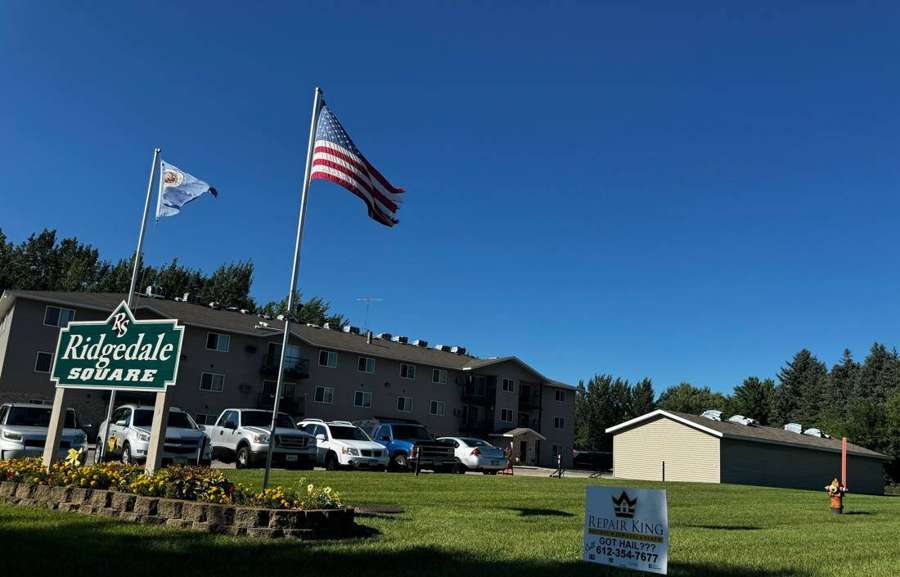 Apartment complex sign and buildings on Ridge Avenue NE in Hutchinson, MN during Repair King's re-roof, August 2024