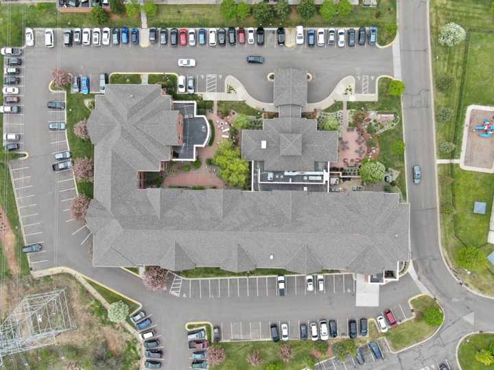 Straight-down drone view of the Hilton Garden Inn roof in Maple Grove, showing its courtyards, gables and hips, May 2019