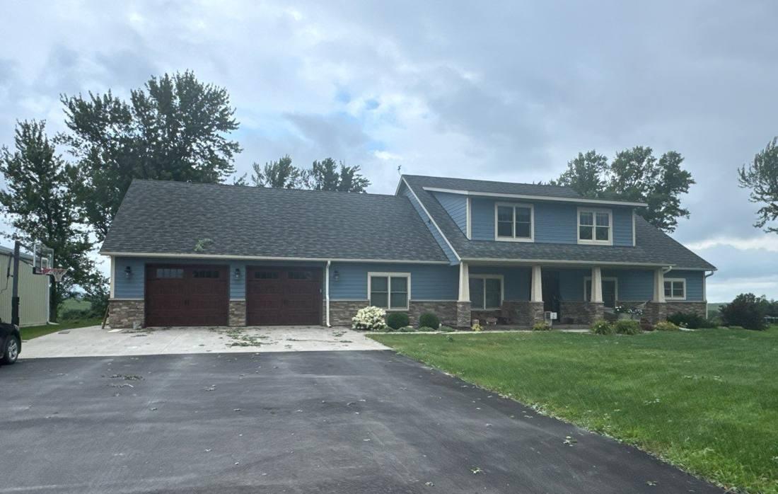 Home on the edge of Goodhue photographed during a roof and siding inspection, August 2024